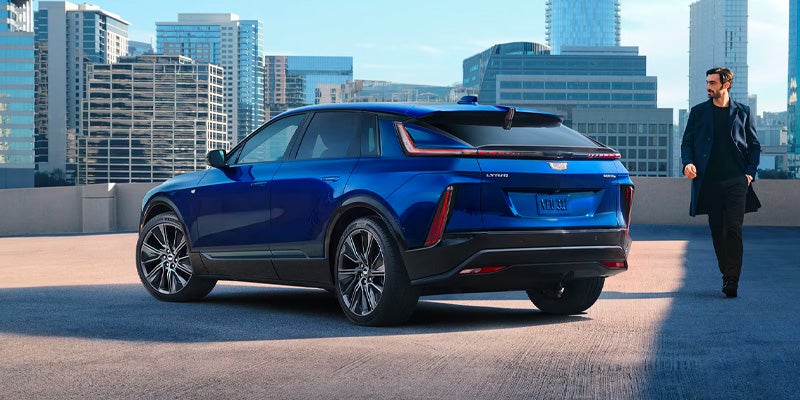 A men walking towards blue car